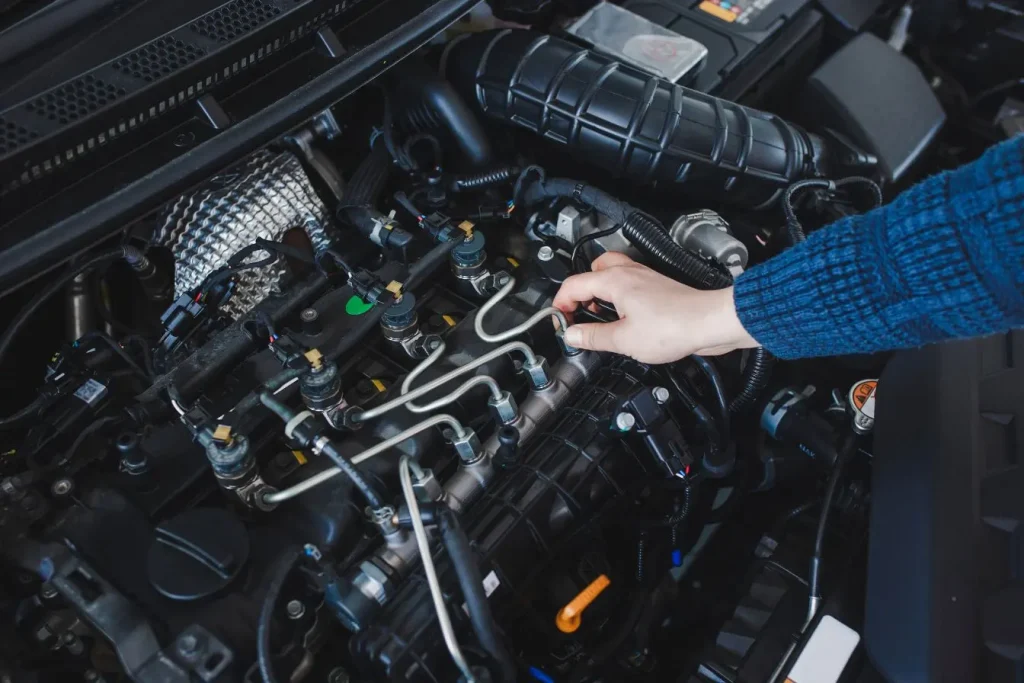 Gros plan sur moteur avec intervention manuelle, scène évoquant un problème de système antipollution