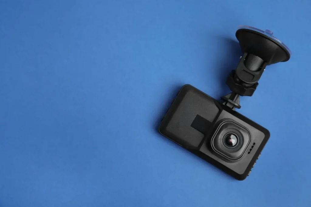 Vue rapprochée d’une dashcam noire avec support illustrant un équipement pour enregistrement routier