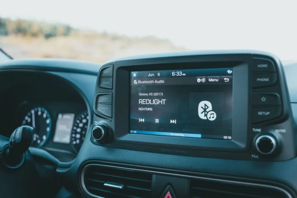 Écran central d’une voiture affichant lecture Bluetooth, image illustrant autoradio moderne et interface multimédia embarquée.