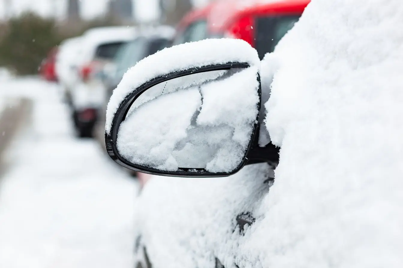 rétroviseur recouvert de neige Voiture stationnée avec miroir latéral couvert de givre