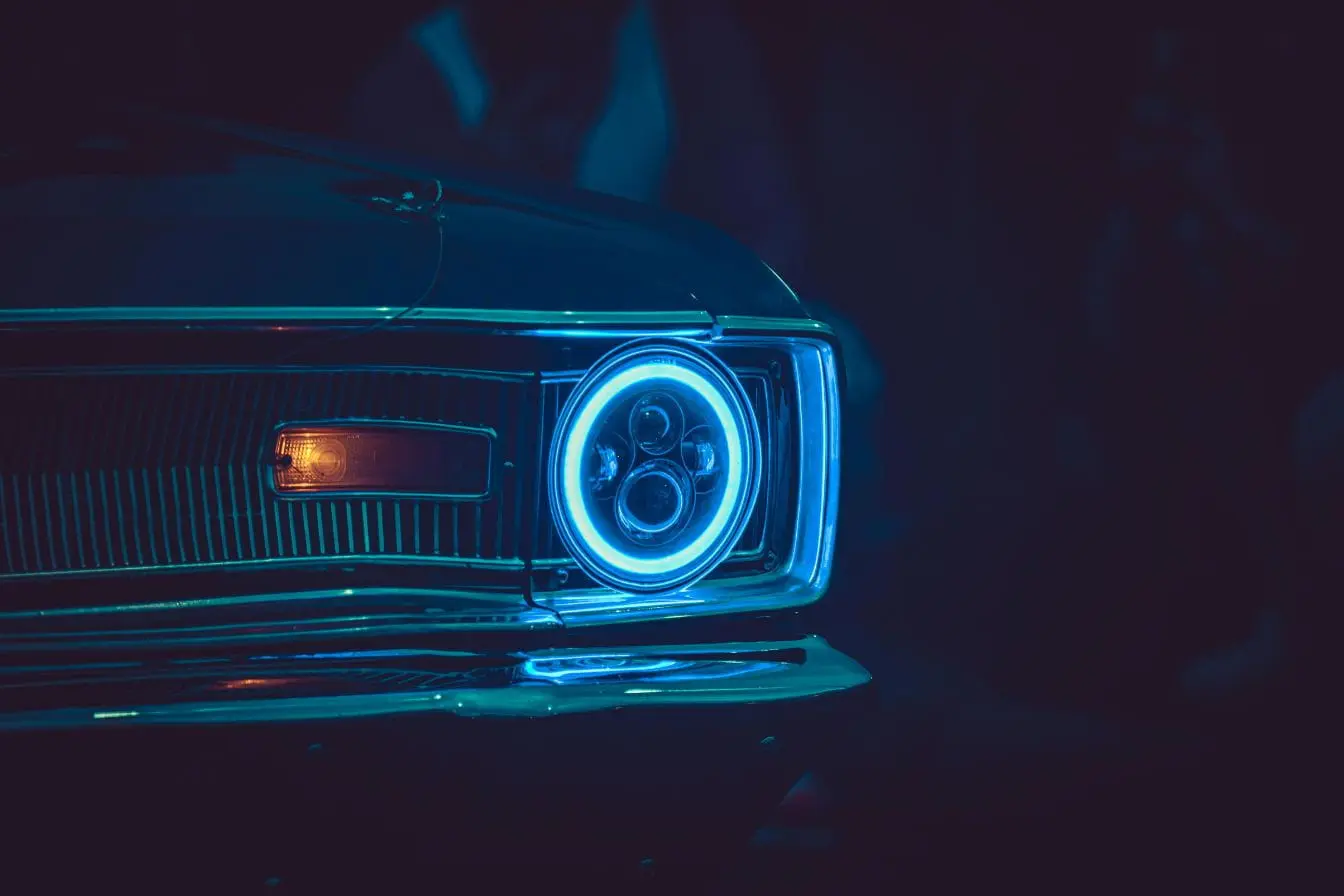 Anneau néon reflétant la vigilance et la précision des phares LED sur une carrosserie classique.